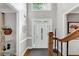 Bright foyer featuring hardwood floors, staircase, and an elegant front door with sidelights at 10400 Groomsbridge Rd, Alpharetta, GA 30022