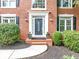 Elegant front entrance with a decorative door, white trim, and manicured landscaping at 10400 Groomsbridge Rd, Alpharetta, GA 30022