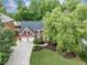 A beautiful brick home featuring a well-manicured lawn and a three-car garage at 10400 Groomsbridge Rd, Alpharetta, GA 30022