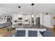 Open kitchen features granite countertops, stainless steel appliances, bar seating, and backyard views at 10400 Groomsbridge Rd, Alpharetta, GA 30022