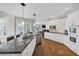 Bright kitchen features white cabinetry, granite countertops, stainless steel appliances and hardwood floors at 10400 Groomsbridge Rd, Alpharetta, GA 30022