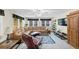 Spacious living room has windows, an area rug, a comfy couch, a ceiling fan, and plenty of room at 10400 Groomsbridge Rd, Alpharetta, GA 30022