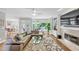Spacious living room with a fireplace, large windows, hardwood floors, and backyard access at 10400 Groomsbridge Rd, Alpharetta, GA 30022
