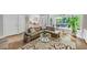 Cozy Gathering room featuring comfortable seating, large windows, access to the backyard, and hardwood floors at 10400 Groomsbridge Rd, Alpharetta, GA 30022