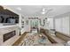 Well lit living room with hardwood floors, fireplace, a large sofa, and creative shelving at 10400 Groomsbridge Rd, Alpharetta, GA 30022