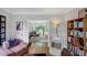 Comfortable living room showcasing hardwood floors and an open view to a sunroom at 10400 Groomsbridge Rd, Alpharetta, GA 30022