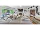 Spacious living room features a large sectional sofa, fireplace, built-ins, and backyard views at 10400 Groomsbridge Rd, Alpharetta, GA 30022