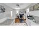 Bright home office with a desk, sleeper sofa, built-ins, ceiling fan, and a geometric patterned rug at 10400 Groomsbridge Rd, Alpharetta, GA 30022