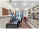 A home office featuring a built-in desk, custom shelving and cabinets, and a window to let the natural light in at 10400 Groomsbridge Rd, Alpharetta, GA 30022