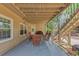 Spacious patio beneath a wooden deck features an outdoor dining set, perfect for entertaining at 10400 Groomsbridge Rd, Alpharetta, GA 30022