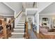 Spacious foyer boasting an open staircase with wood and white trim and hardwood floors at 10400 Groomsbridge Rd, Alpharetta, GA 30022