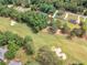 An aerial view shows the golf course community, houses, and green landscape at 1585 Lake Dow Rd, Mcdonough, GA 30252