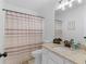Bathroom features granite countertops and a neutral shower curtain at 1585 Lake Dow Rd, Mcdonough, GA 30252