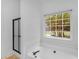 Bathroom showcasing a tub, shower with a door, and a window with a view at 1585 Lake Dow Rd, Mcdonough, GA 30252