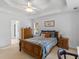 Bright bedroom with a wooden bed frame, trey ceiling, ceiling fan, and a window for natural light at 1585 Lake Dow Rd, Mcdonough, GA 30252