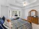 Bright bedroom featuring a wooden bed, desk by the window, and a wooden dresser at 1585 Lake Dow Rd, Mcdonough, GA 30252
