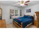 Comfortable bedroom features a ceiling fan, natural light, and decor at 1585 Lake Dow Rd, Mcdonough, GA 30252