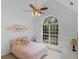 Bright bedroom boasts a large window, ceiling fan, and decor at 1585 Lake Dow Rd, Mcdonough, GA 30252