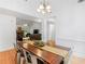 Open-concept dining area with a wooden table and view of the living room with fireplace at 1585 Lake Dow Rd, Mcdonough, GA 30252
