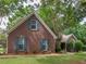 Traditional brick home with dormer windows, attached garage, and a well-manicured front yard at 1585 Lake Dow Rd, Mcdonough, GA 30252