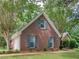 Brick home with dormer windows, attached garage, and a well-manicured front yard with green shutters at 1585 Lake Dow Rd, Mcdonough, GA 30252