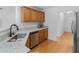 Well-equipped kitchenette with stainless steel sink, dishwasher, and wood cabinets at 1585 Lake Dow Rd, Mcdonough, GA 30252
