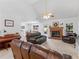Spacious living room featuring a fireplace and comfortable seating, piano, and dining area at 1585 Lake Dow Rd, Mcdonough, GA 30252