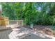 A wood back deck looks out over a yard with mature trees and lush landscaping at 2012 Variations Ne Dr, Atlanta, GA 30329