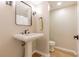 Clean powder room with a pedestal sink, modern faucet, and neutral color scheme at 2012 Variations Ne Dr, Atlanta, GA 30329