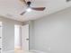 Neutral bedroom with ceiling fan, gray walls, and a view into an adjoining room at 2012 Variations Ne Dr, Atlanta, GA 30329
