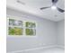This bedroom features a modern ceiling fan, large window and neutral paint at 2012 Variations Ne Dr, Atlanta, GA 30329