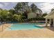 A relaxing community pool has many lounge chairs and a building with bathrooms and changing area at 2012 Variations Ne Dr, Atlanta, GA 30329