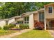 Charming townhome exterior with lush landscaping, green lawn, and direct walkway access at 2012 Variations Ne Dr, Atlanta, GA 30329