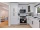 Updated kitchen with stainless appliances, shaker cabinets and lots of natural light from rear sliding door at 2012 Variations Ne Dr, Atlanta, GA 30329