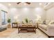 Well-lit living room with wood floors, fireplace, and a comfortable seating area and a ceiling fan at 2012 Variations Ne Dr, Atlanta, GA 30329