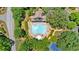 Aerial view of the community pool, tennis courts, and clubhouse, all with lush green landscaping and mature trees at 1311 Cobblemill Nw Way, Kennesaw, GA 30152