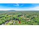 Aerial view of a home located in a neighborhood with lush trees and rolling hills in the distance at 1311 Cobblemill Nw Way, Kennesaw, GA 30152
