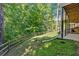 Serene backyard with wooden fence, mature trees, and walkout basement; ideal for outdoor enjoyment at 1311 Cobblemill Nw Way, Kennesaw, GA 30152