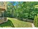 Lush backyard with a wooden fence and mature trees, offering privacy and a peaceful setting at 1311 Cobblemill Nw Way, Kennesaw, GA 30152