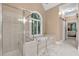 Bathroom showcases a glass enclosed shower, soaking tub, and vanity with a window providing natural light at 1311 Cobblemill Nw Way, Kennesaw, GA 30152