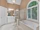 Bathroom features a soaking tub, glass enclosed shower, vanity with a large window offering natural light at 1311 Cobblemill Nw Way, Kennesaw, GA 30152