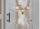Bathroom entrance with sliding barn door to tub and vanity with large mirror in a light and open space at 1311 Cobblemill Nw Way, Kennesaw, GA 30152