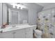 Bathroom featuring white cabinets, a floral shower curtain, and a toilet at 1311 Cobblemill Nw Way, Kennesaw, GA 30152