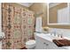 Cozy bathroom featuring a white vanity, patterned shower curtain, and warm lighting at 1311 Cobblemill Nw Way, Kennesaw, GA 30152