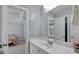 Well-lit bathroom featuring a white vanity with a large mirror, with view into the bedroom at 1311 Cobblemill Nw Way, Kennesaw, GA 30152