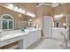 Spacious bathroom with dual sinks, makeup vanity, jacuzzi tub, and large windows for natural light at 1311 Cobblemill Nw Way, Kennesaw, GA 30152