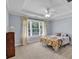 Bright bedroom featuring a ceiling fan, neutral carpet, and a large window at 1311 Cobblemill Nw Way, Kennesaw, GA 30152