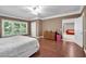 Bedroom with hardwood floors, view to the en-suite and large windows offering views of the backyard at 1311 Cobblemill Nw Way, Kennesaw, GA 30152