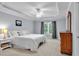 Bedroom featuring neutral carpet, a ceiling fan, and a large window at 1311 Cobblemill Nw Way, Kennesaw, GA 30152
