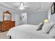 Bedroom featuring neutral carpet, a ceiling fan, and a wooden dresser at 1311 Cobblemill Nw Way, Kennesaw, GA 30152
